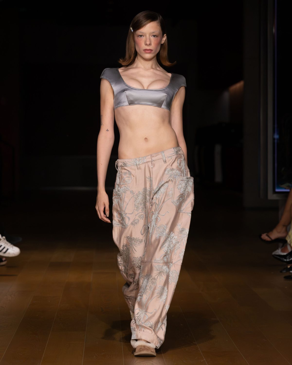 Silver satin bra top with blush pink embroidered pants and fur-lined slippers.