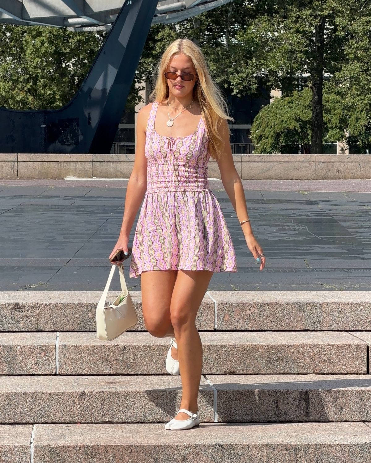 Pink and green patterned summer mini-dress with white mary-jane flats.