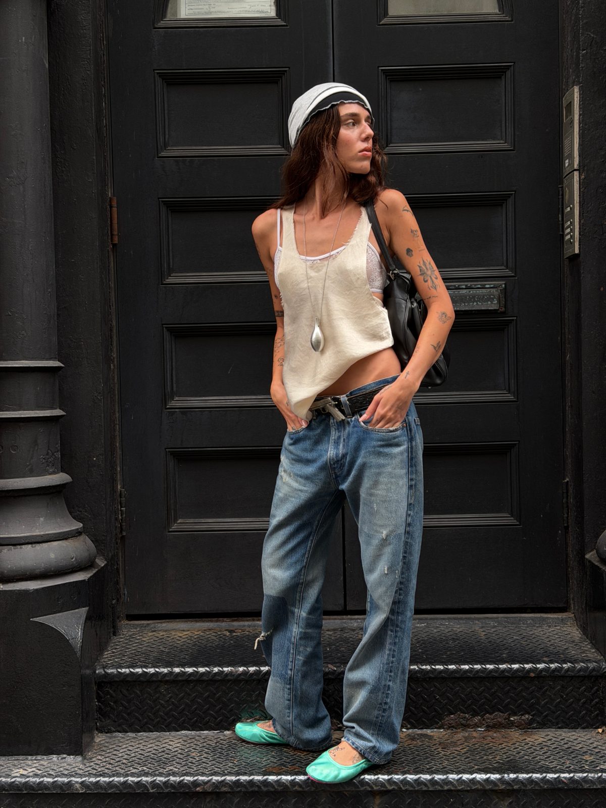 White tank top, baggy ripped jeans, and turquoise ballet flats, with a white and black bandana.