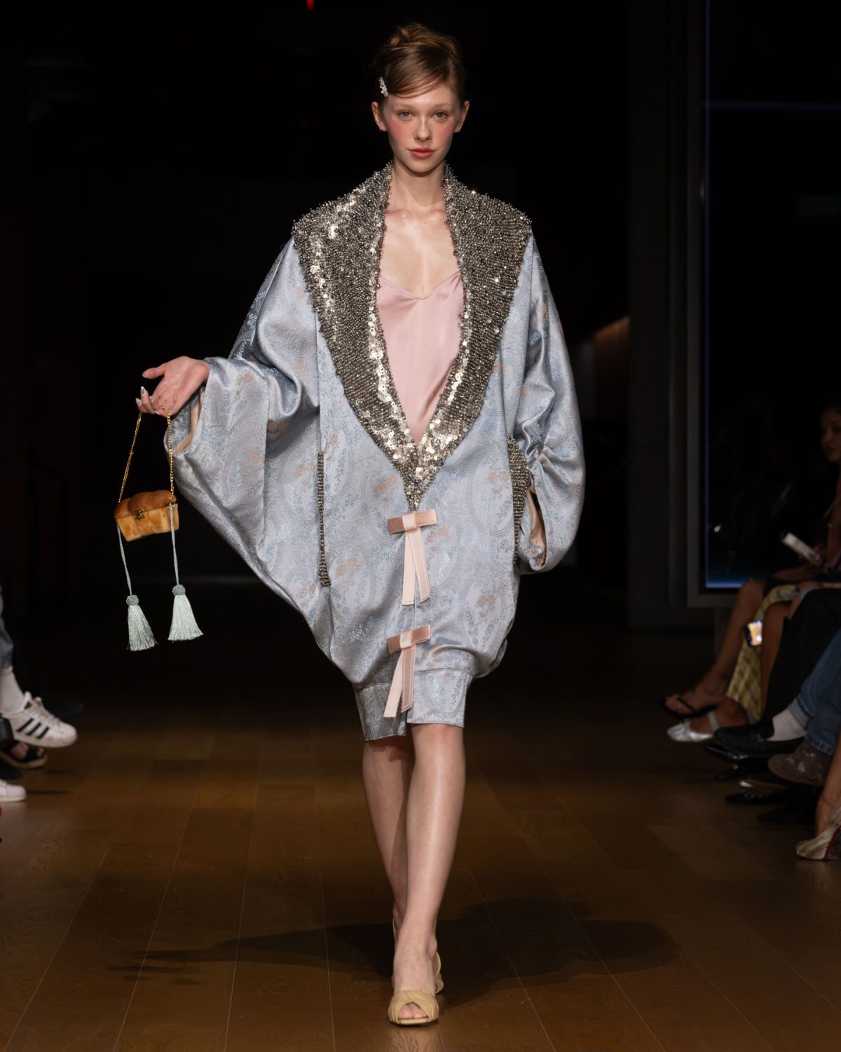 Light blue patterned caftan with sequined collar, pink slip dress, and croissant bag.