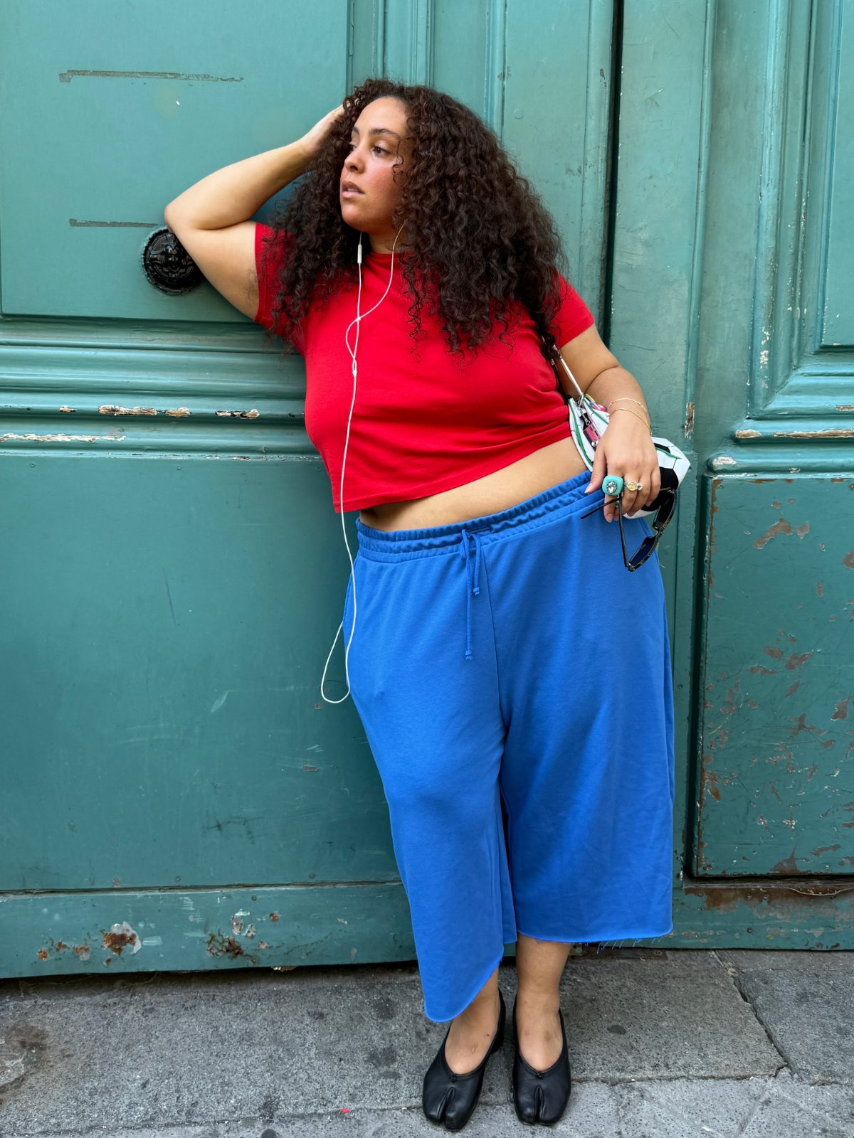 Red crop top, blue sweatpants, and black tabi flats.