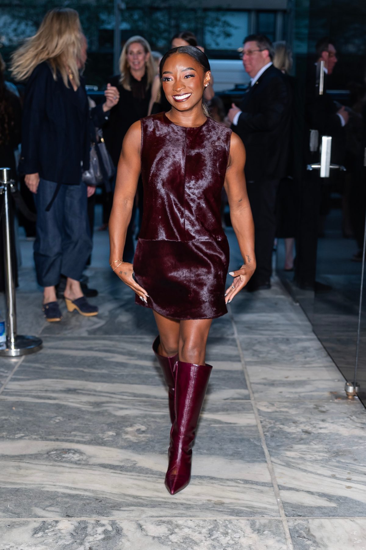 Burgundy faux fur mini dress with matching pointed-toe boots.