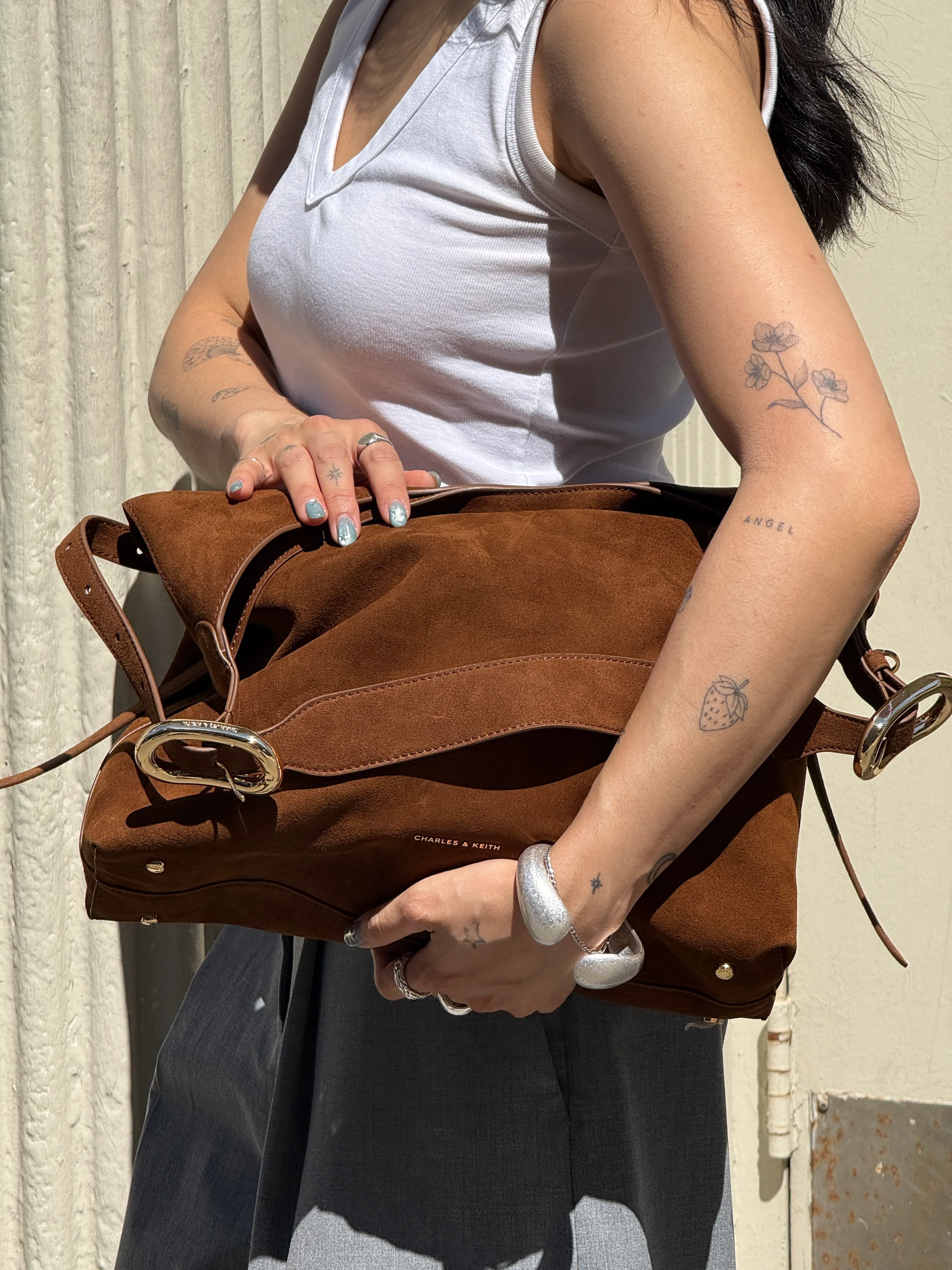 White ribbed tank top, gray trousers, brown suede Charles & Keith bag, and silver jewelry.