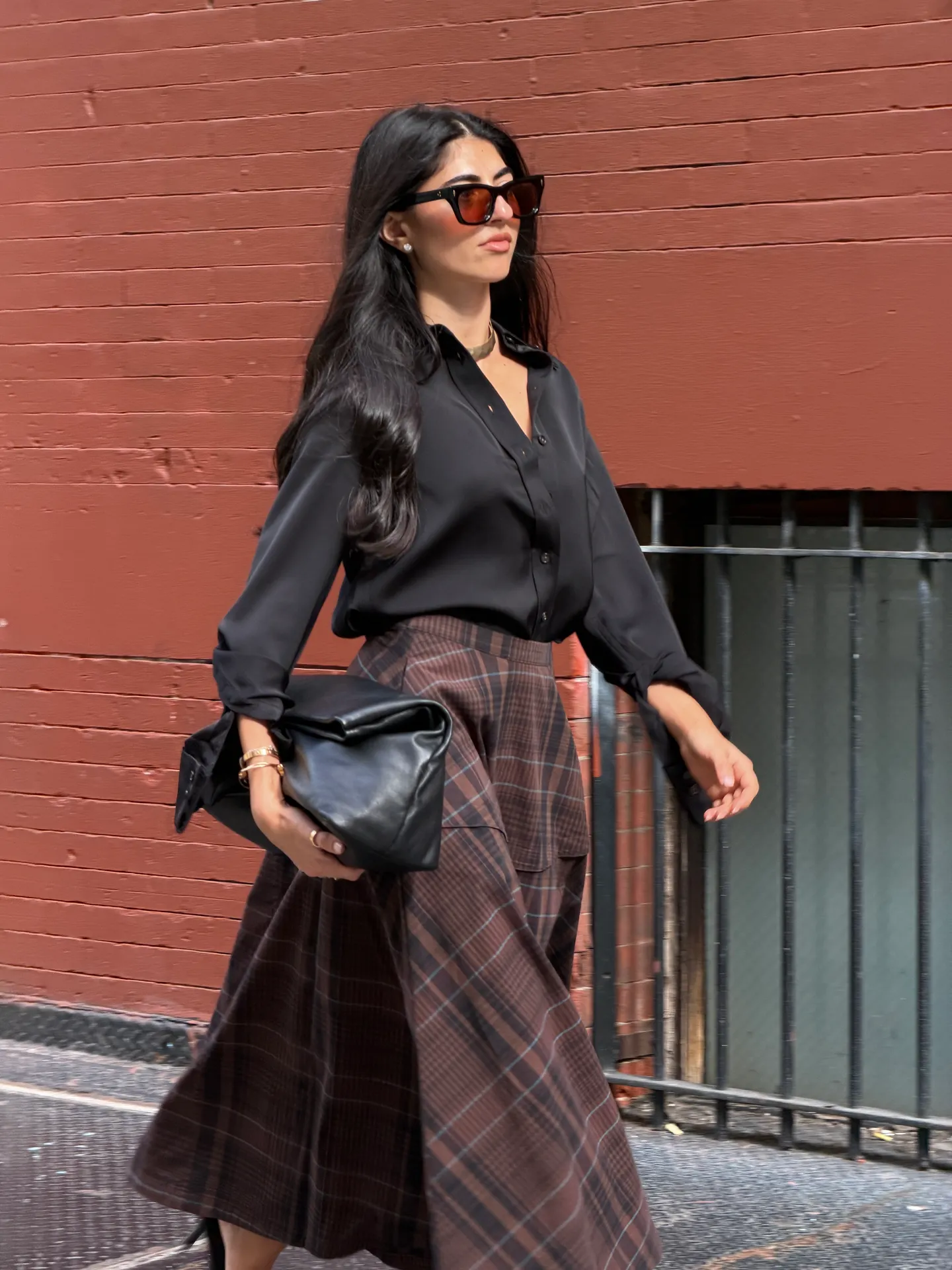 Black button-up shirt, brown plaid maxi skirt, and black clutch.