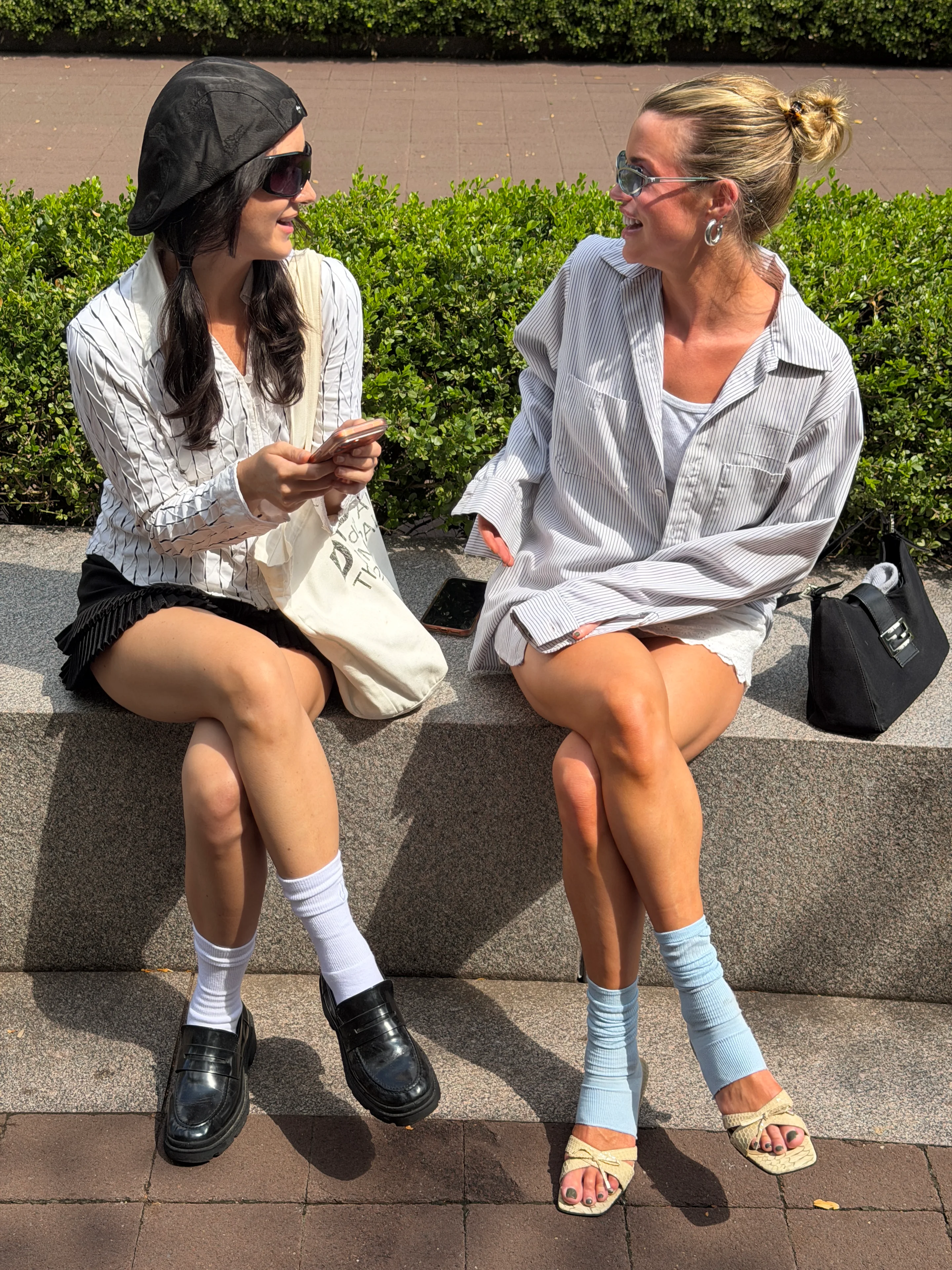 Summer street style with black pleated mini skirt, striped shirts, and sunglasses.