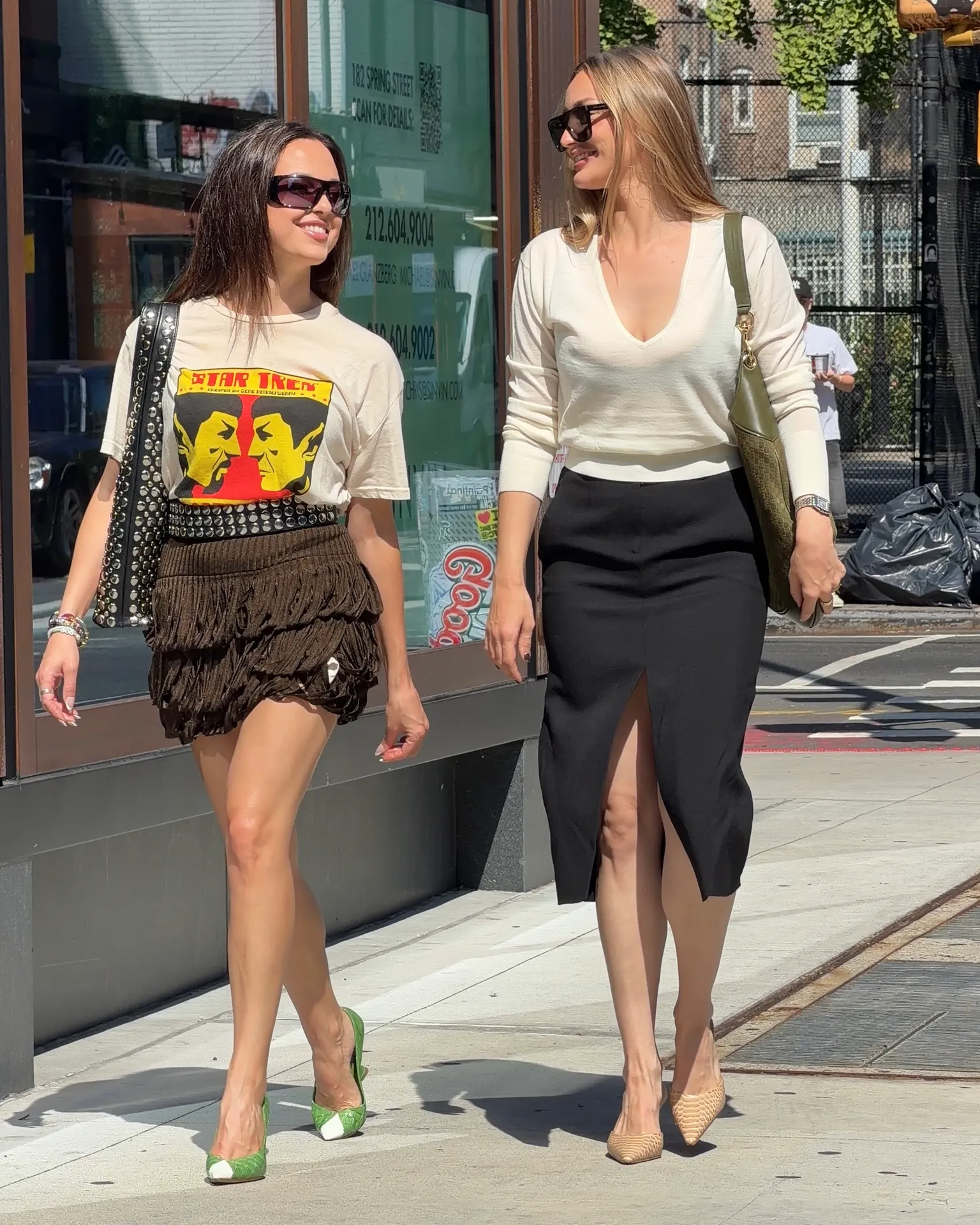 Beige Star Trek tee, brown fringe skirt, green heels; cream V-neck, black midi skirt, nude heels.