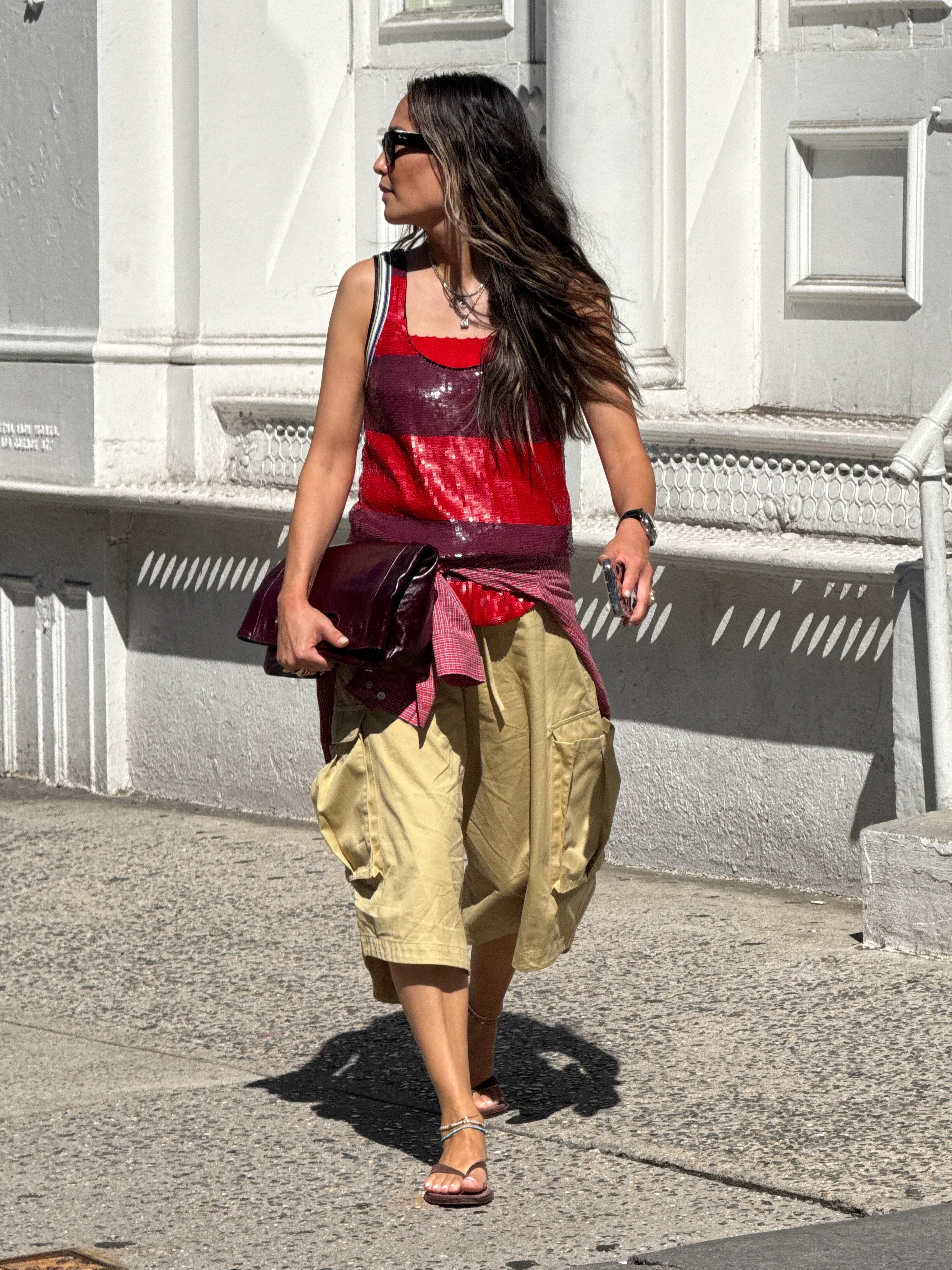 Red and maroon sequin top, tan cargo shorts, red plaid shirt, brown sandals, and a maroon clutch.