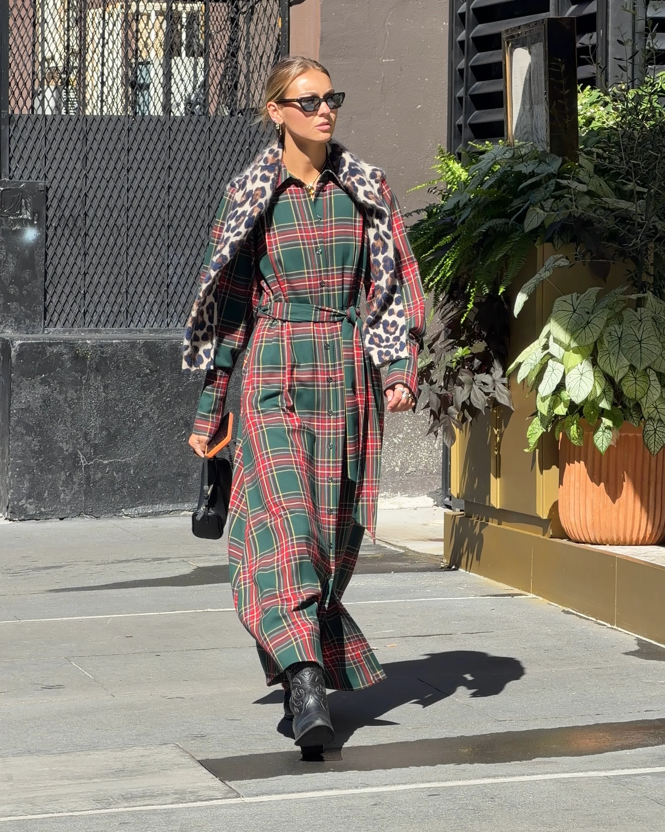 Red and green plaid maxi dress with leopard scarf, black cowboy boots, and sunglasses.